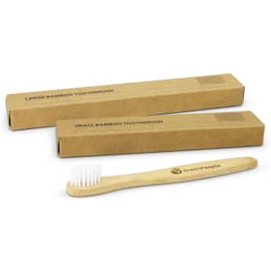 A bamboo toothbrush with a wooden handle and white bristles, accompanied by two brown cardboard boxes.