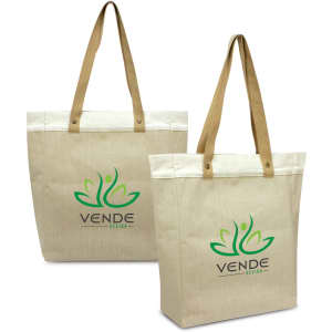 A light beige tote bag with brown handles, featuring a green logo. The bag is made from a durable juco material.