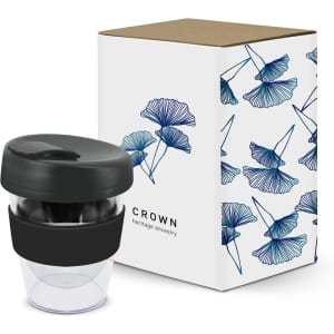 A drink bottle with a black lid and transparent body, accompanied by a decorative box featuring floral designs.