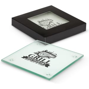 A square glass coaster, clear with a black base and branding, displayed in a black box.
