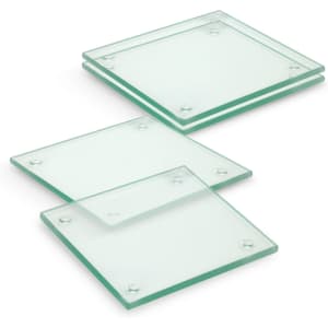 A set of four square glass coasters, featuring a transparent green tint with rounded corners.