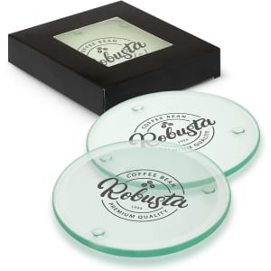 A set of four round glass coasters in light green, displayed in a black packaging with a branding logo.