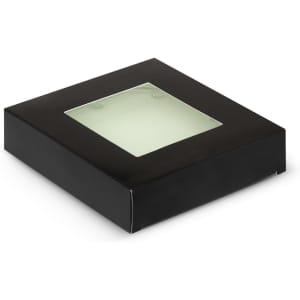 A square black box with a transparent window on top, containing a round glass coaster set.