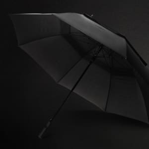 A 76cm black storm umbrella with a sturdy frame and a handle, featuring a branded logo.