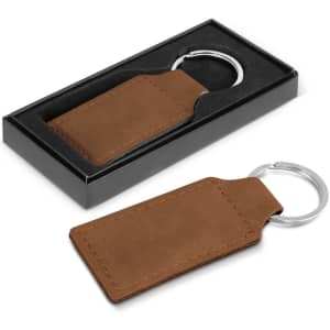 A brown leather key ring with a silver metal attachment, presented in a black gift box.