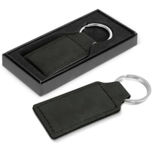A green faux leather key ring with a silver metal ring, displayed in a black box.
