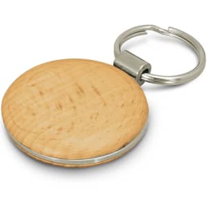 A round wooden key ring with a silver metal keychain attachment. The wood has a light, natural finish.