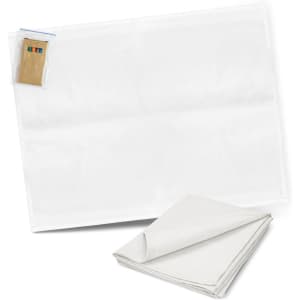 A white cotton tea towel with a folded corner, accompanied by a set of colouring pens.