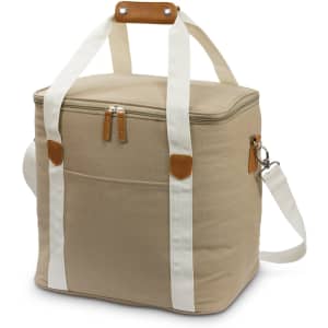 A tan canvas cooler bag with white straps, a brown handle, a zip closure, and a front pocket.