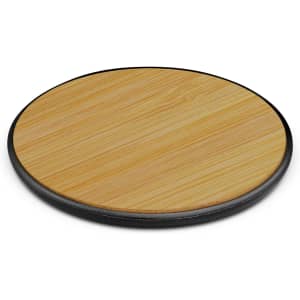 A bamboo wireless charger with a circular design and a black base, featuring a smooth wooden surface.