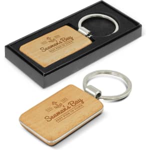 A rectangular key ring with a wooden surface and a metal keychain, presented in a black gift box.