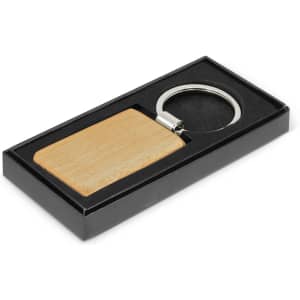 A wooden rectangle key ring in a black gift box, featuring a metal key ring attachment.
