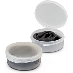 A black silicone straw folded inside a clear plastic case, with the case partially open.