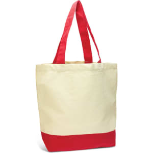 A canvas tote bag in cream with a red bottom and red handles, featuring a logo.