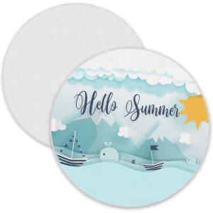 A round beach towel featuring a blue and white nautical design with a sun, clouds, and boats. It has a logo.