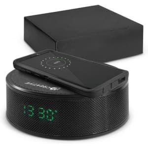 A black wireless charger and Bluetooth speaker with a digital clock display, accompanied by a black box.