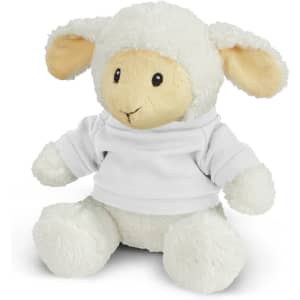 A soft cream-coloured lamb plush toy wearing a white top, with floppy ears and a friendly expression.