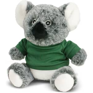 A plush koala toy in grey and white, wearing a green shirt, with round eyes and soft fur. It features a branding logo.