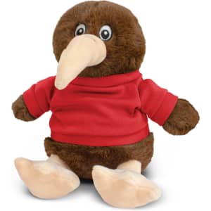 A brown kiwi plush toy wearing a red shirt, sitting with a rounded body and large feet. It has big eyes and a long beak.