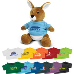 A brown kangaroo plush toy wearing a blue shirt, surrounded by various colourful T-shirts. It has a logo on the shirt.