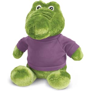 A green crocodile plush toy wearing a purple shirt, featuring large eyes and a friendly expression.