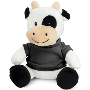 A plush cow toy with a black and white colour scheme, wearing a grey shirt and sitting upright.