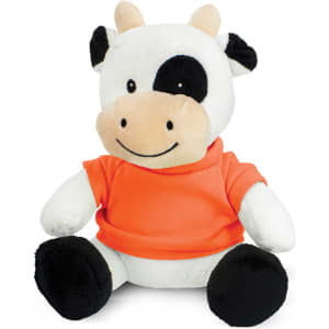 A cute cow plush toy with black and white fur, wearing an orange t-shirt and sitting upright on a white background.