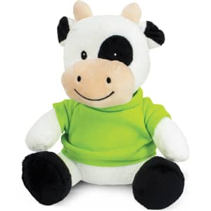 A plush cow toy with black and white fur, wearing a green shirt. It has a smiling face and soft features.