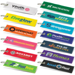 A collection of woven key rings in various colours, each with a logo or branding.