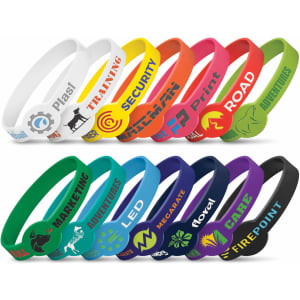 A collection of silicone wristbands in various colours, featuring debossed designs and logos.