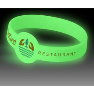 A glow-in-the-dark silicone wristband in green, featuring a logo and decorative elements.
