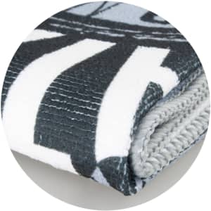A folded sports towel in grey and white, featuring a patterned design and a logo.