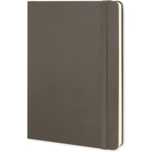 A large, dark green Moleskine classic hard cover notebook with an elastic band closure.