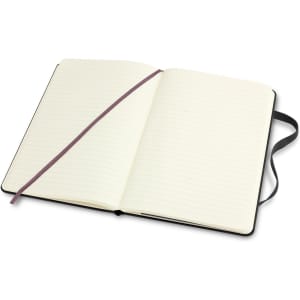 A large, black Moleskine classic hard cover notebook with blank pages and a ribbon bookmark.