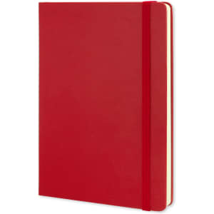 A large red Moleskine classic hard cover notebook with an elastic closure and blank pages.