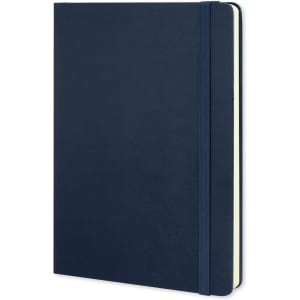 A large Moleskine Classic hard cover notebook in navy blue with an elastic band and rounded edges.