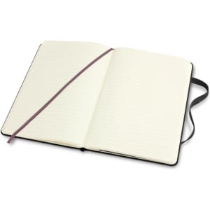 A medium hard cover notebook in black with lined pages and a ribbon bookmark, featuring an interior without visible text.