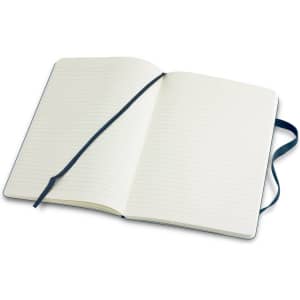 A large, soft cover notebook with blank lined pages and a blue ribbon bookmark inside.