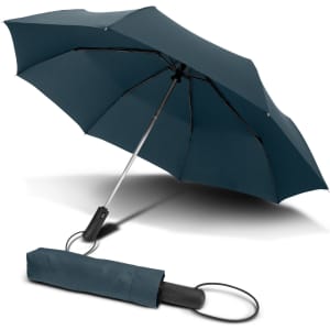 A compact teal umbrella with a black handle, resting next to its matching protective sleeve.