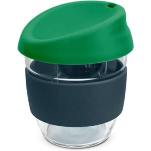 A drink bottle made of clear borosilicate glass with a green silicone lid and a dark blue silicone grip.
