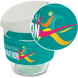 A drink bottle featuring a clear borosilicate glass body, a teal silicone sleeve, and a white lid with a logo.