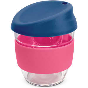 A drink bottle made of clear borosilicate glass with a pink silicone sleeve and a navy blue lid.