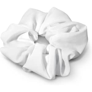 A white hair scrunchie with a textured fabric design, featuring a circular shape and soft pleats.
