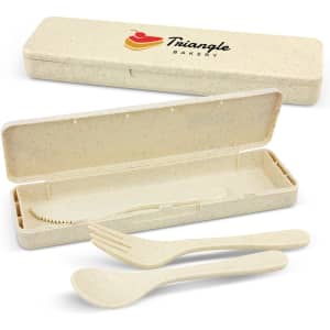 A cutlery set in cream colour featuring a knife, fork, and spoon, housed in a matching case with a logo.