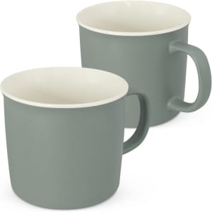 A drink mug set in muted green with cream interior, featuring a simple handle and a smooth finish.