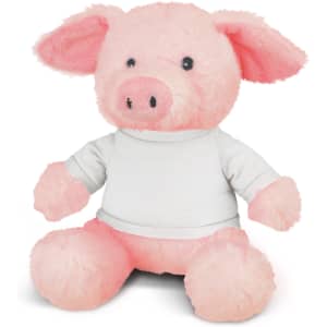 A pink plush pig toy wearing a white shirt, sitting upright with soft, fluffy ears and a round face.