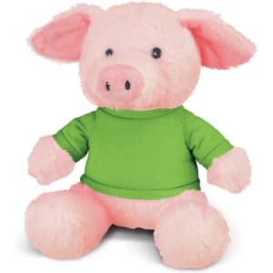 A pink plush pig toy wearing a green shirt, featuring soft ears and a friendly expression.