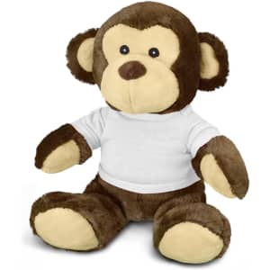 A brown monkey plush toy wearing a white t-shirt, featuring soft texture and large round ears.