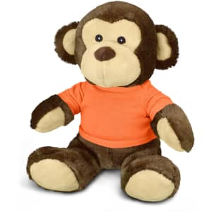 A brown and cream plush monkey toy wearing an orange shirt, featuring large ears and a friendly expression.