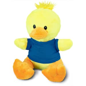 A yellow duck plush toy with an orange beak and feet, wearing a blue shirt. It has a tuft of fur on its head.